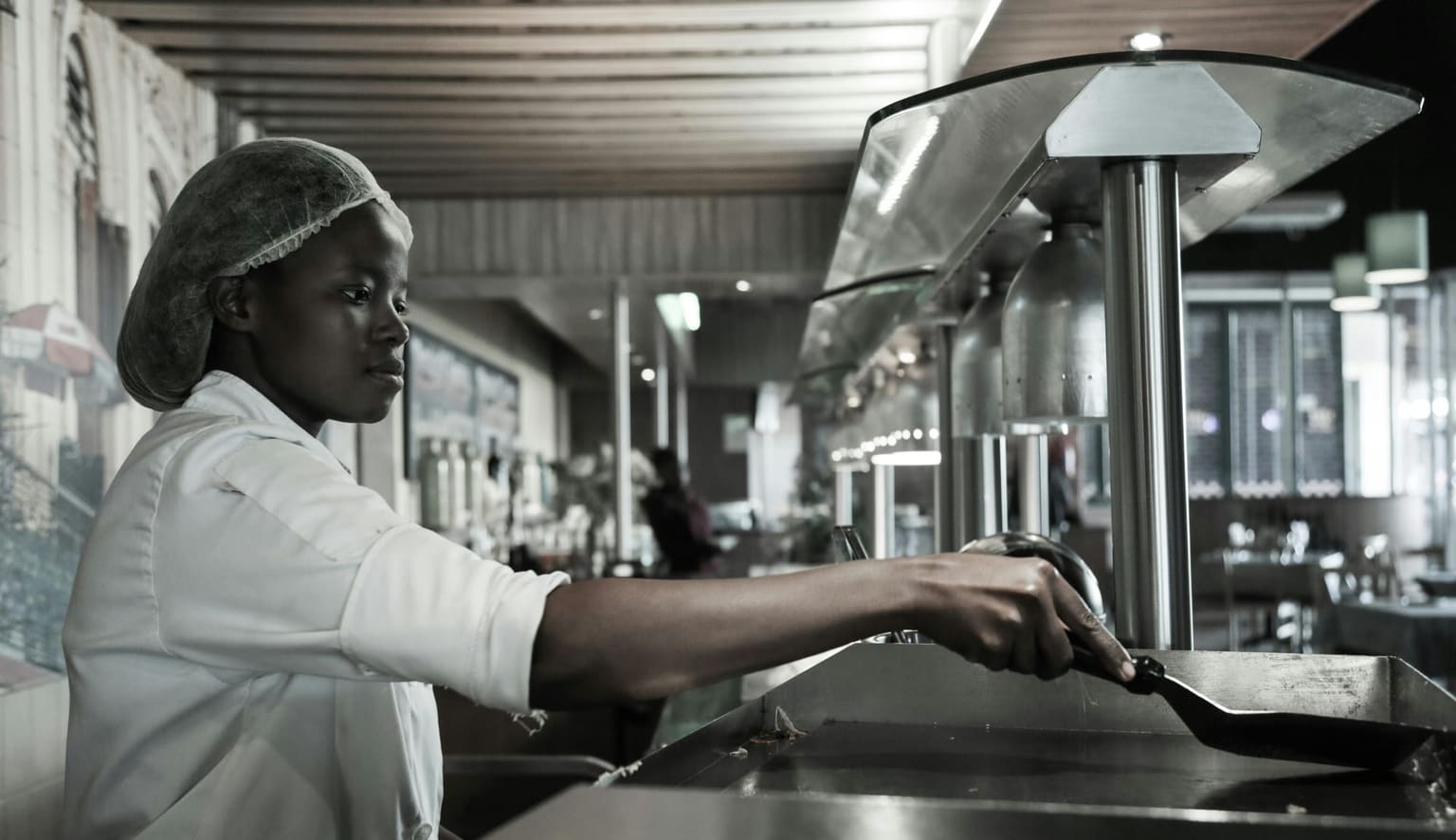 African chef working in a professional hospitality service kitchen