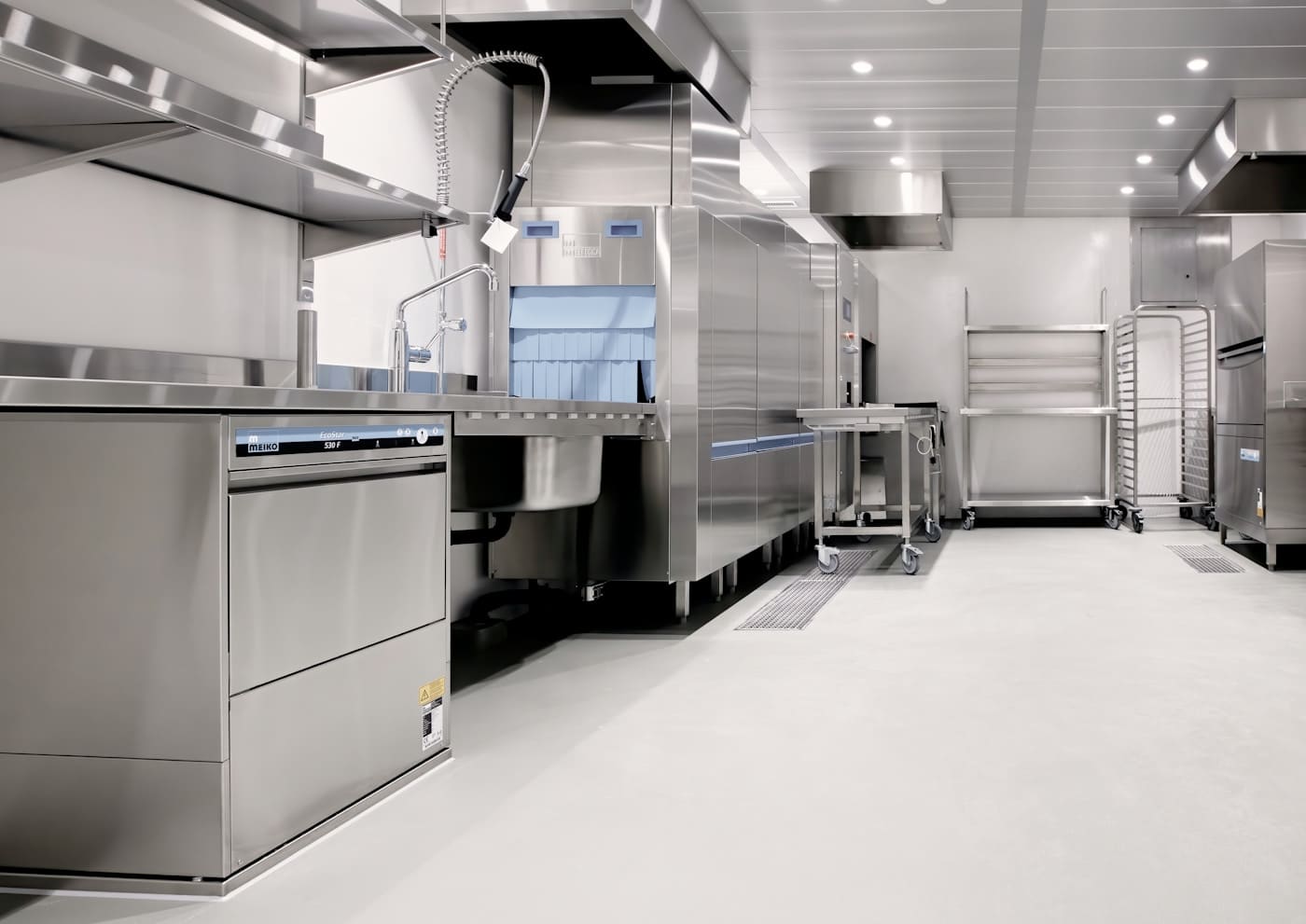 Kitchen equipment consultant reviewing commercial appliance specifications with a client