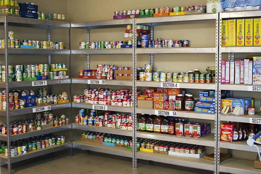 Large metal storage shelving stocked with food supplies